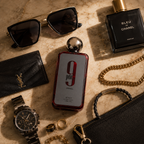 Afnan 9PM Rebel perfume arranged with luxury watch, sunglasses, jewelry, and leather accessories in premium flatlay composition.