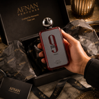 Afnan 9PM Rebel perfume being presented from premium gift box with luxury tissue paper and elegant unboxing presentation.