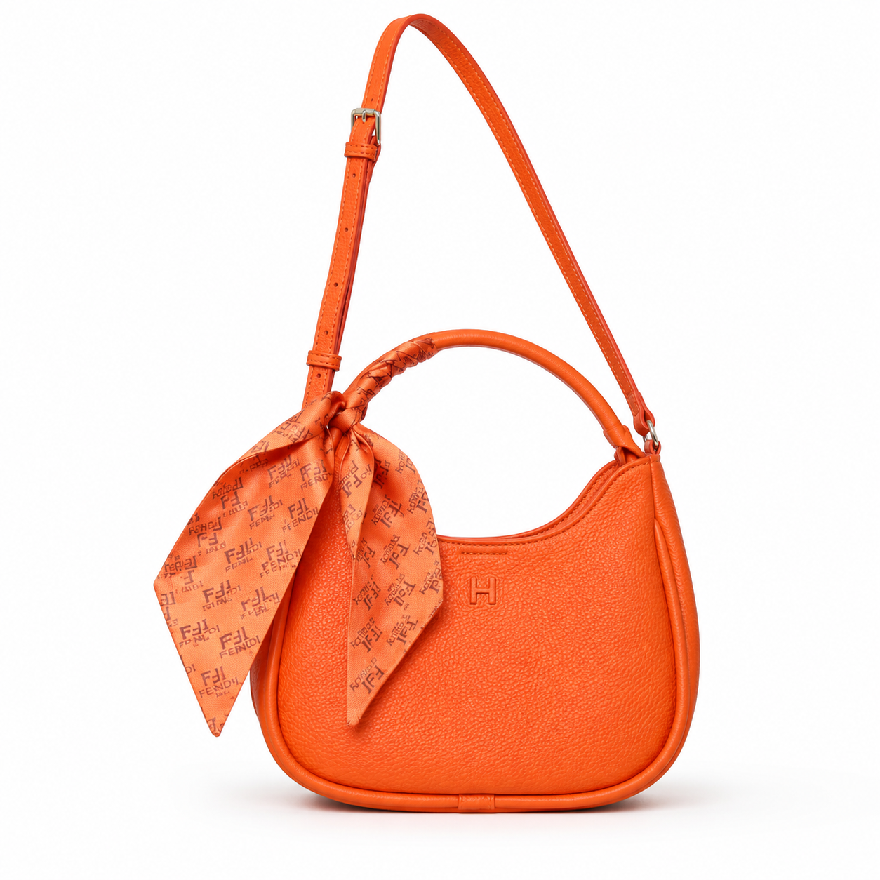 An orange pebbled leather shoulder bag with a matching orange monogram scarf tied in a knot at the side, shown on a clean white background.