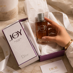 Premium flatlay featuring Dior Joy perfume with sunglasses, jewelry, watch, and luxury leather accessories