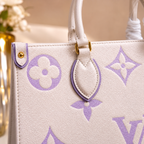White handbag with purple floral pattern on a blurred background