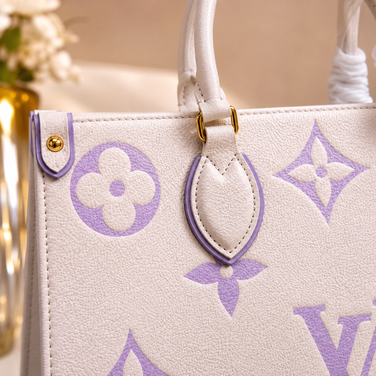 White handbag with purple floral pattern on a blurred background