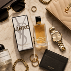 Premium flatlay featuring Libre perfume with sunglasses, jewelry, watch, and luxury leather accessories