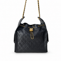 A black quilted leather shoulder bag with gold-tone chain straps and a gold interlocking CC clasp, photographed on a clean white background.