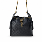 A black quilted leather shoulder bag with gold-tone chain straps and a gold interlocking CC clasp, photographed on a clean white background.