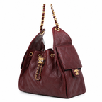 A Chanel hobo bag in quilted burgundy leather with gold-tone hardware, featuring a front flap pocket with a CC logo, a top chain strap, and a drawstring closure.