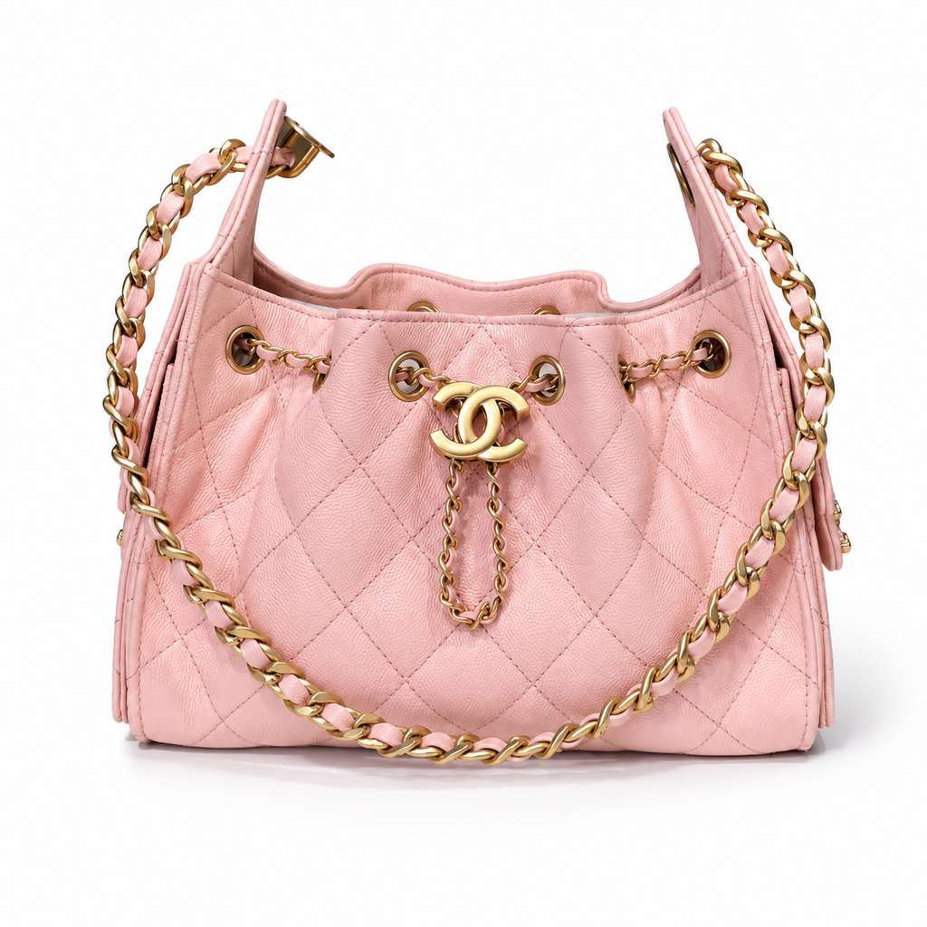 A light pink quilted leather shoulder bag with gold-tone hardware, featuring a prominent interlocking CC logo on a chain strap and a matching chain draped across the front, set against a plain white background.