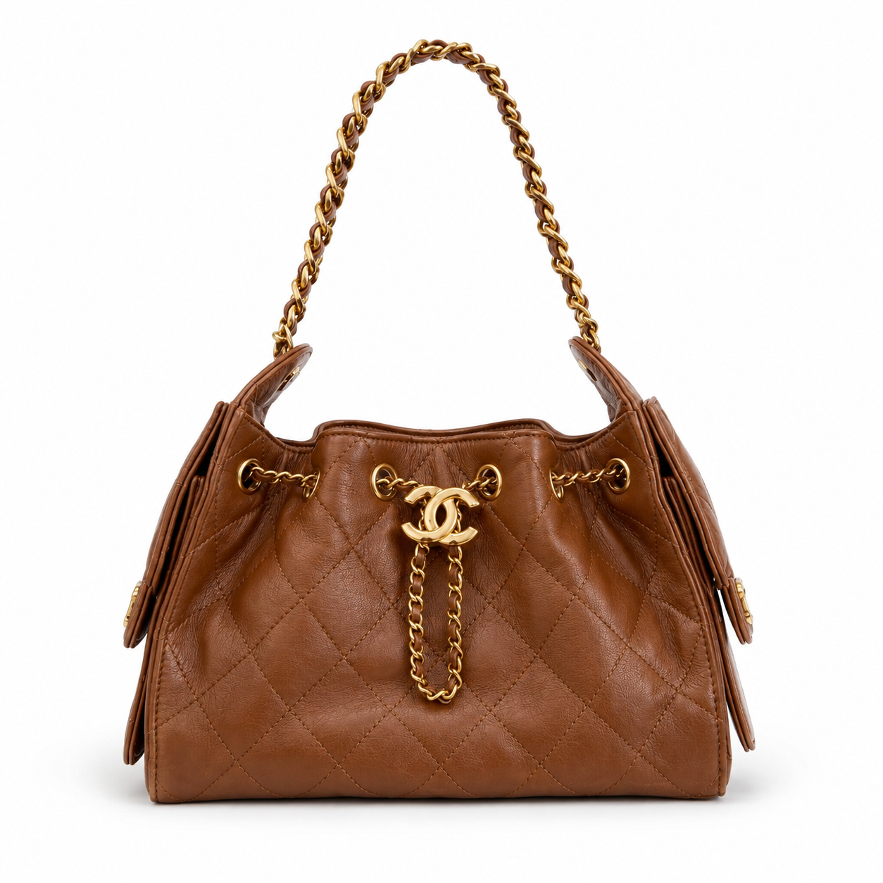 A brown quilted leather handbag with gold-tone chain straps and hardware, featuring a prominent interlocking CC logo on the front, set against a plain white background.