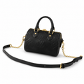 Luxury black embossed leather handbag with gold hardware and detachable strap on white background