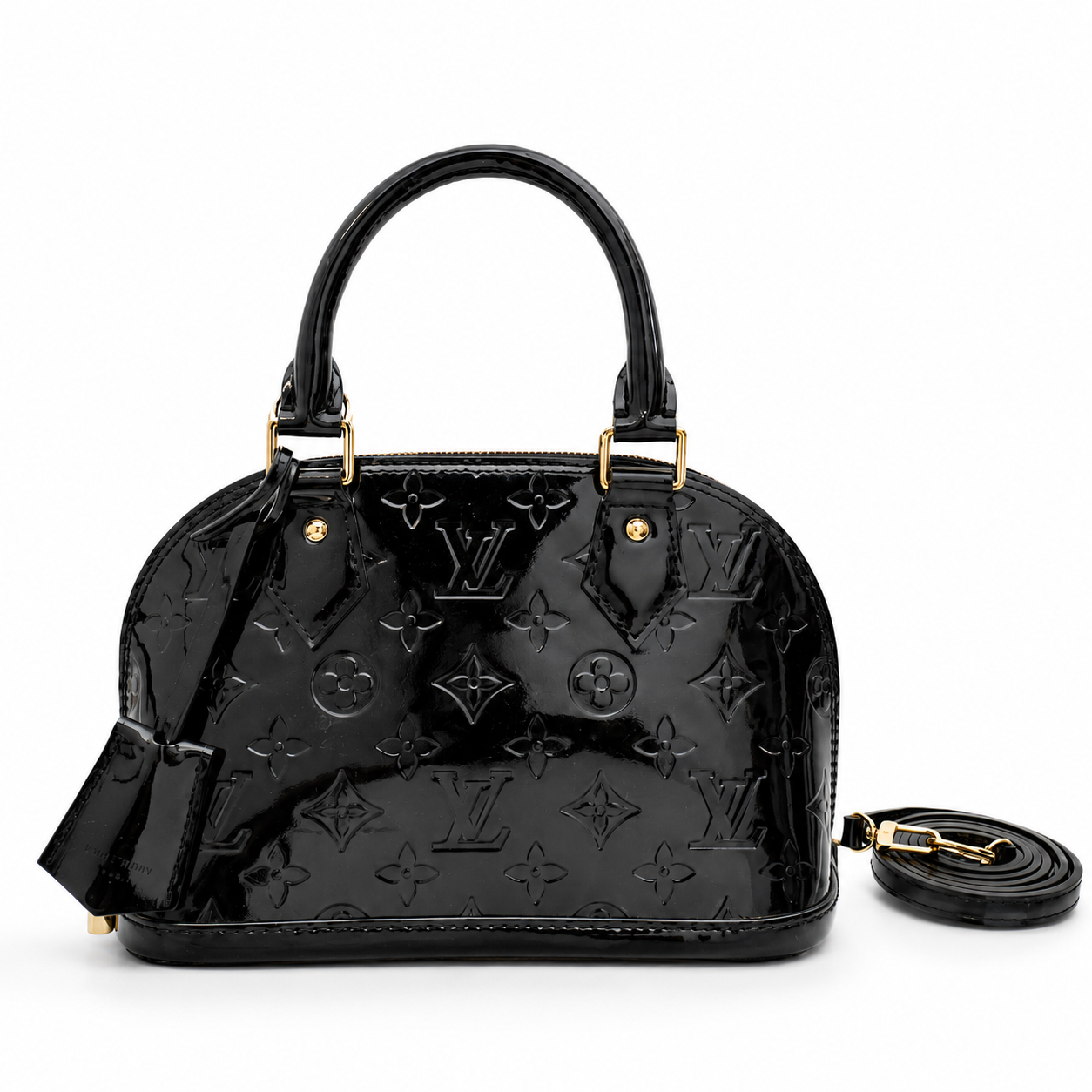 Luxury black patent leather handbag with embossed monogram design and gold hardware on white background.