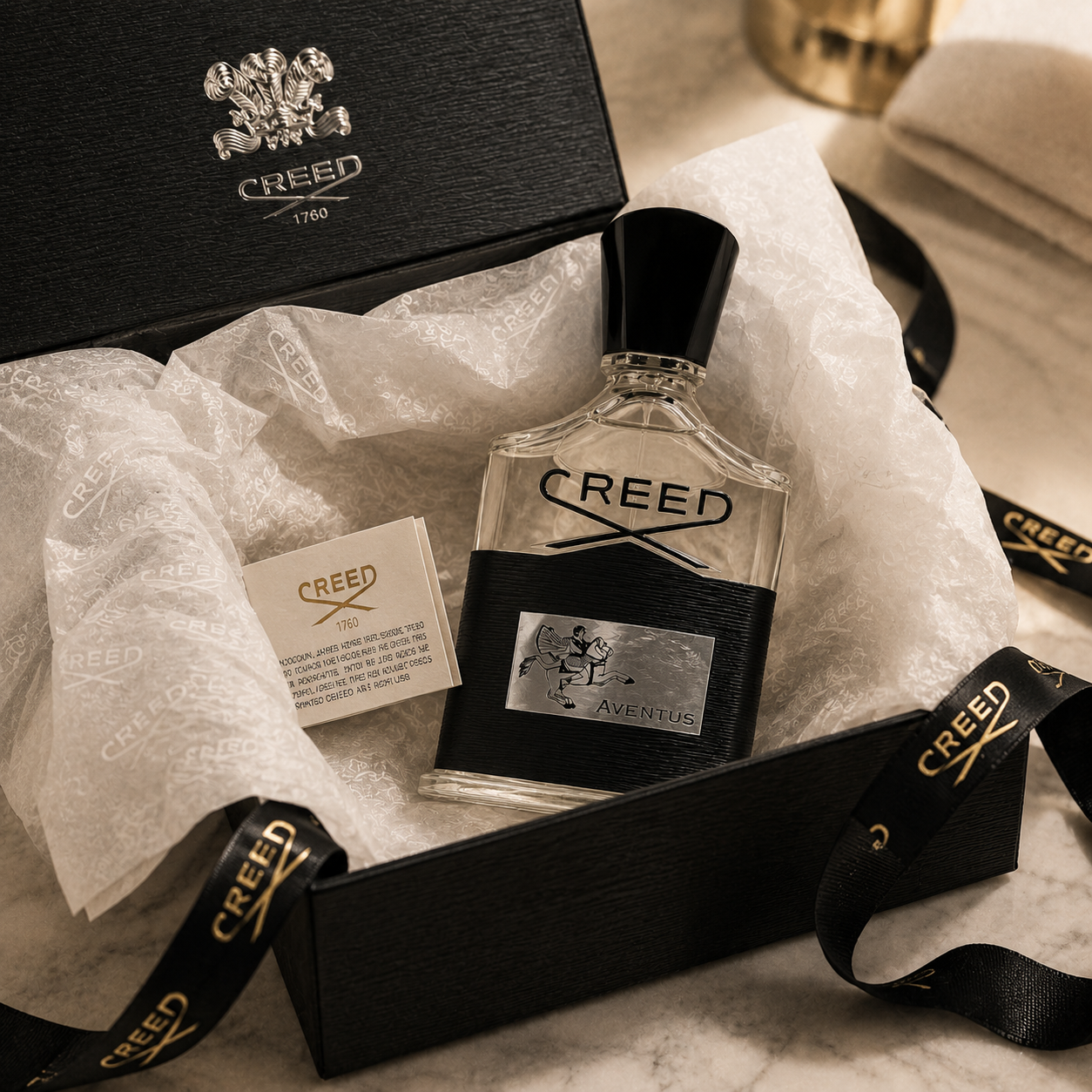 Creed Aventus perfume inside premium luxury packaging with tissue paper and elegant ribbon styling.