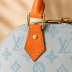 Luxury monogram women’s handbag styled in elegant Dubai-inspired boutique environment with soft golden lighting