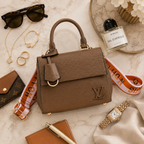 Premium flatlay composition featuring luxury handbag, sunglasses, perfume, jewelry, and watch on marble background.