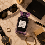 Luxury perfume flatlay featuring sunglasses, watch, jewelry and leather accessories in sophisticated Dubai luxury lifestyle composition