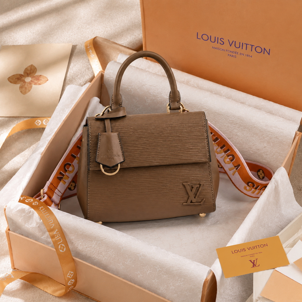 Elegant luxury handbag displayed inside premium gift packaging with tissue paper and ribbon styling.
