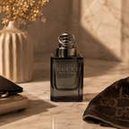 Luxury men's fragrance bottle styled on an elegant marble surface with soft beige tones and sophisticated editorial photography aesthetic.