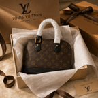 Luxury monogram dome handbag presented in elegant premium gift packaging with tissue paper and ribbon for a luxury unboxing experience.