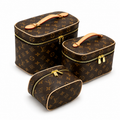 Luxury monogram makeup bag set with gold zipper vanity cases on white background