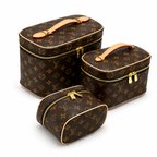 Luxury monogram makeup bag set with gold zipper vanity cases on white background