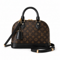 Elegant luxury monogram handbag with top handle and crossbody strap on white background