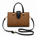 Luxury brown monogram tote handbag with black leather handles and crossbody strap on white background