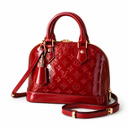 Luxury red patent leather women’s handbag with embossed detailing and gold hardware on white background.