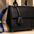 Elegant black luxury handbag displayed in premium Dubai-inspired boutique environment with warm golden lighting