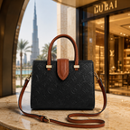 Premium embossed tote bag arranged with sunglasses, perfume, jewelry, and luxury accessories in flatlay composition