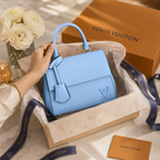 Designer-inspired blue handbag with structured shape, luxury strap, and sophisticated modern fashion look.