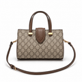 Luxury women’s monogram tote handbag with brown leather handles and adjustable shoulder strap on white background