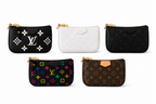 Luxury women's monogram wristlet pouch with premium textured finish and gold zipper on a white background.