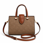 Luxury women’s monogram tote bag with brown leather handles and adjustable shoulder strap on white background