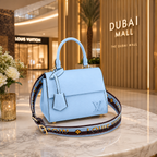 Premium textured blue leather-style handbag with adjustable luxury strap and gold-tone hardware.