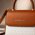 Close-up view of luxury handbag showing premium leather texture, refined stitching, gold logo hardware, and elegant craftsmanship details.