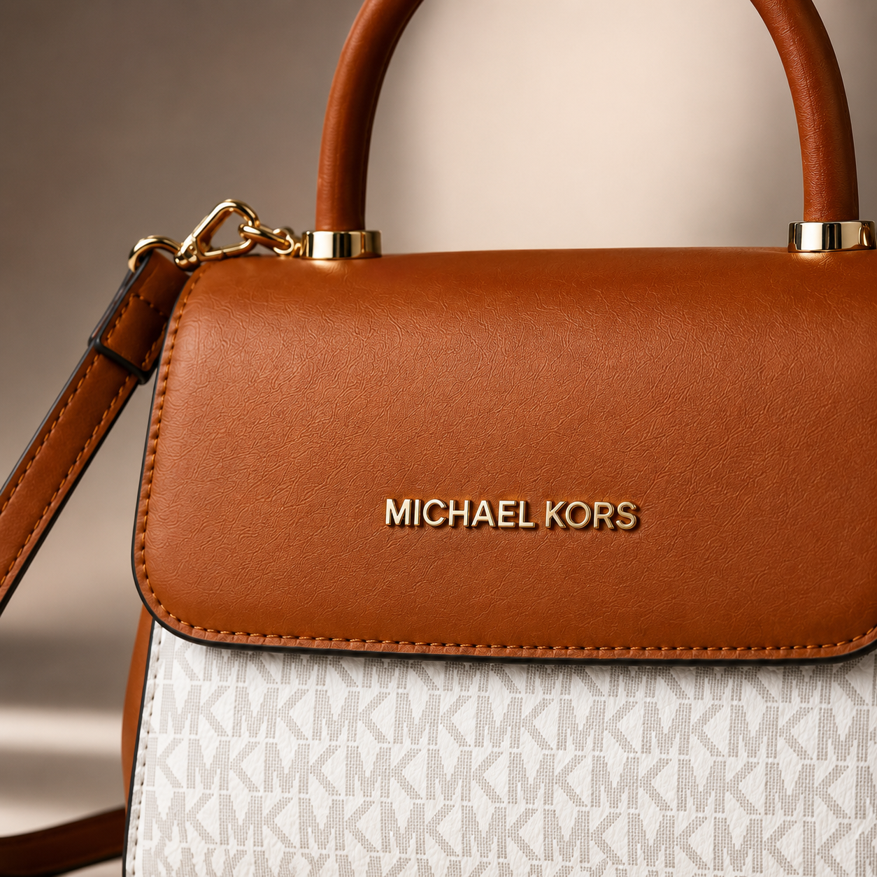 Close-up view of luxury handbag showing premium leather texture, refined stitching, gold logo hardware, and elegant craftsmanship details.