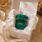 Versace Crystal Emerald perfume presented inside a premium luxury gift box with tissue paper and ribbon packaging.
