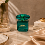 Versace Crystal Emerald perfume bottle styled on a marble surface with luxury accessories and elegant décor.