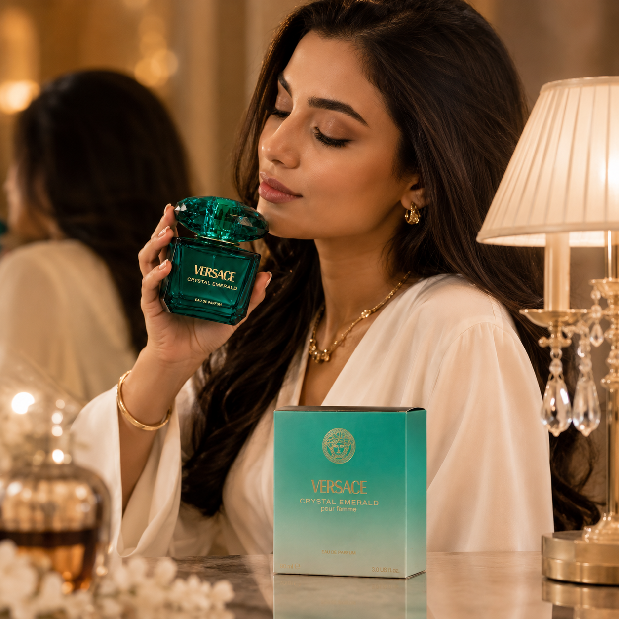 Elegant woman enjoying Versace Crystal Emerald Eau De Parfum in a luxury lifestyle setting.