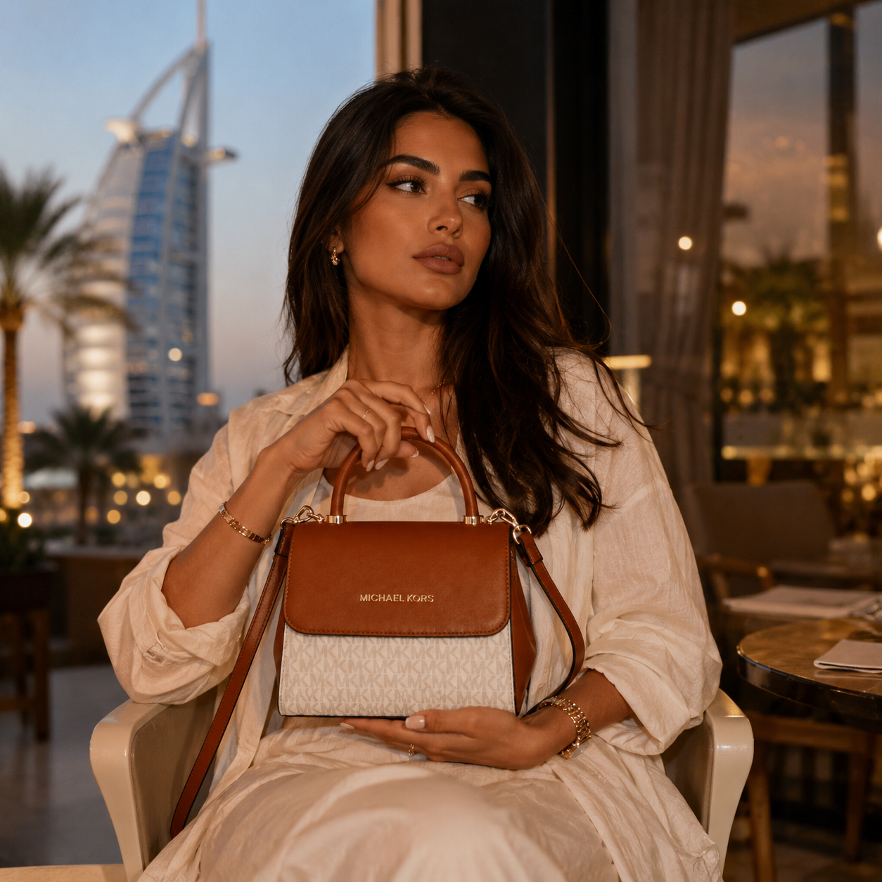 Elegant woman holding luxury monogram handbag in upscale Dubai fashion lifestyle setting with premium evening aesthetic.